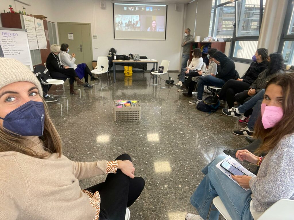 circle of participants at a hybrid meeting